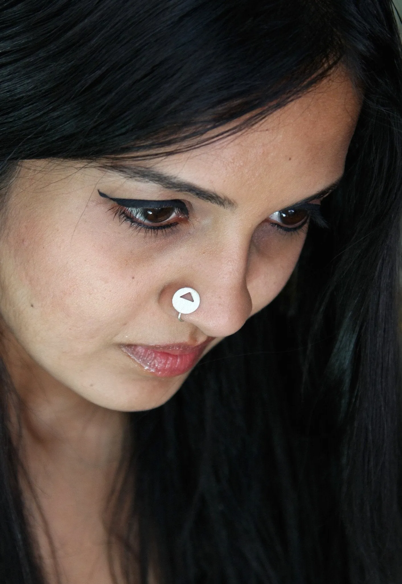 Chic, brush-finish, circular nose pin with a cut-out