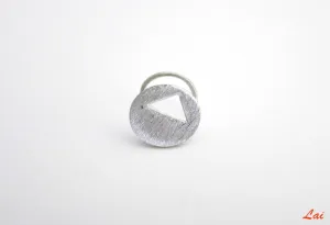 Chic, brush-finish, circular nose pin with a cut-out